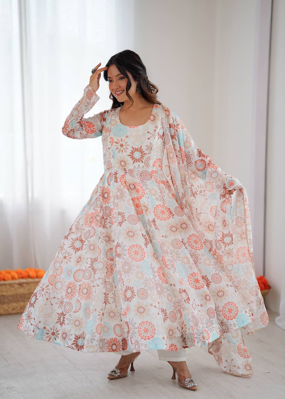A joyful woman poses gracefully, twirling in a white organza floral anarkali gown with a matching dupatta, showcasing its full flair.