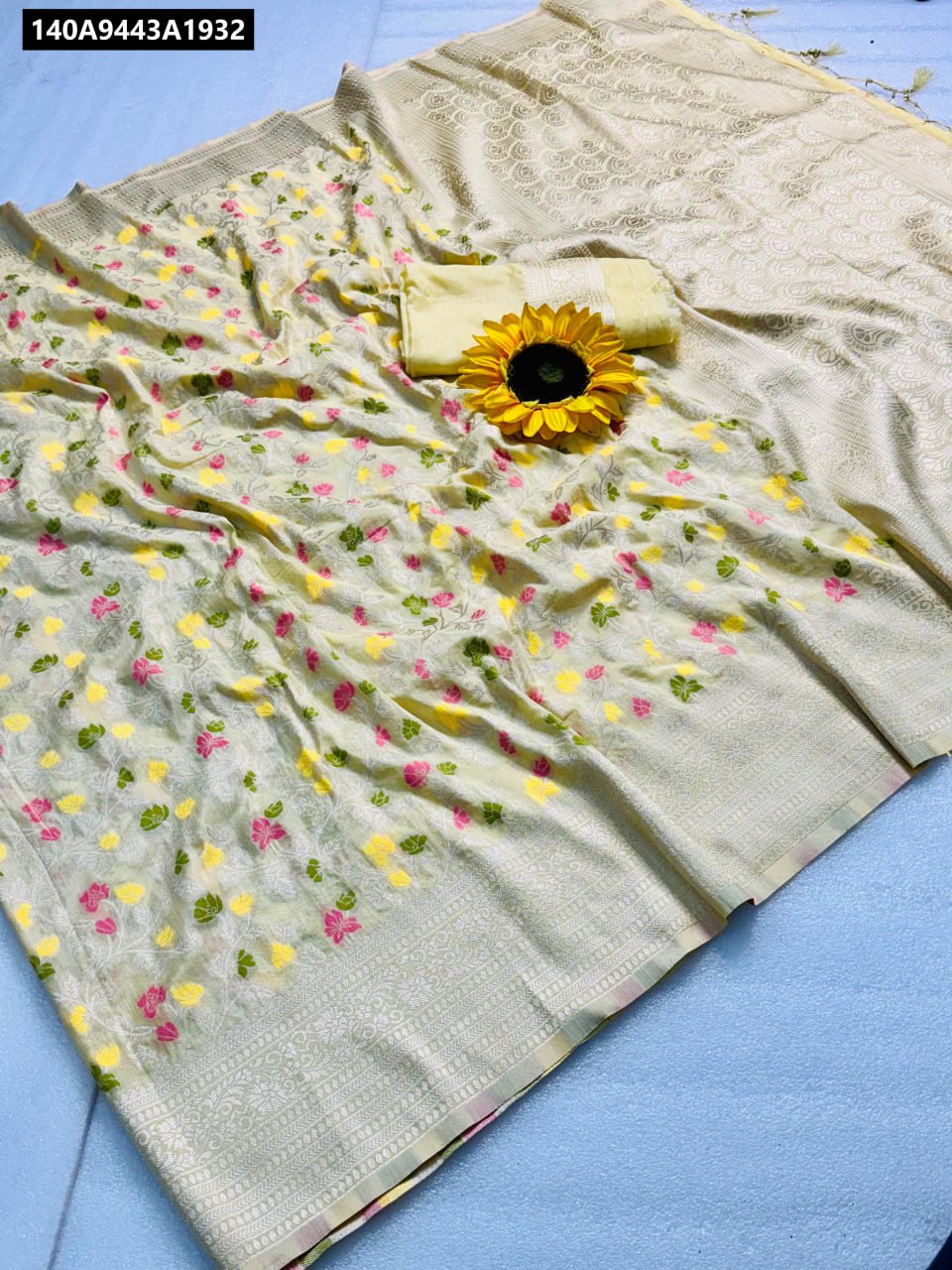 Flat lay of TRENDBUY Chiku Pashmina Bandhani Saree with intricate border work.