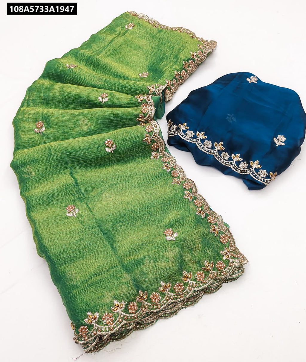 Emerald Green Fendy Chiffon Saree with Moti and Diamond embroidery, paired with a contrast Teal Blue blouse piece.