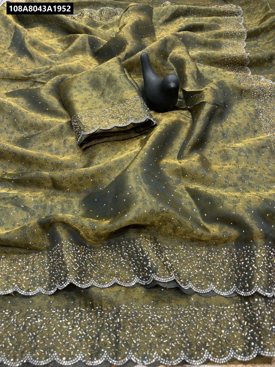 TRENDBUY Fandy Satin Saree in Olive Gold with self-weaving zari and sparkling Sirwoski border, with matching blouse piece