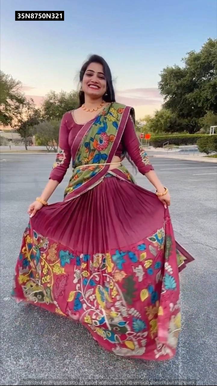 Model joyfully twirling outdoors, showcasing the full flair of the TRENDBUY plum Kalamkari print lehenga with a green dupatta, a vibrant full-body shot.