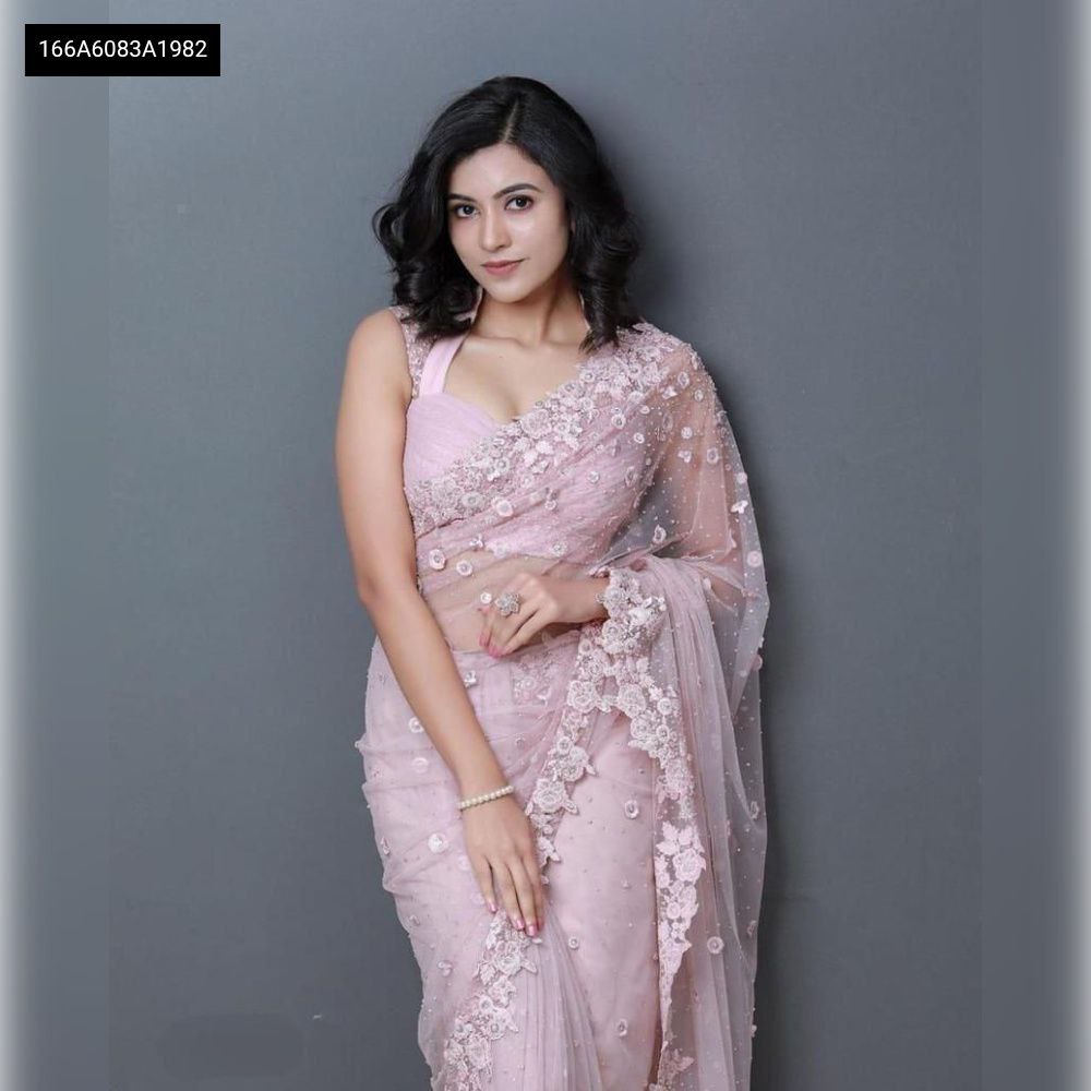 Full body, front-facing shot of a model looking directly at the camera, elegantly draped in a stunning lavender embroidered organza saree.
