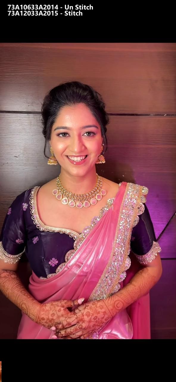 Elegant model showcasing a shimmering pink Jimmy Choo satin saree with a detailed purple mirror work blouse, front-facing.