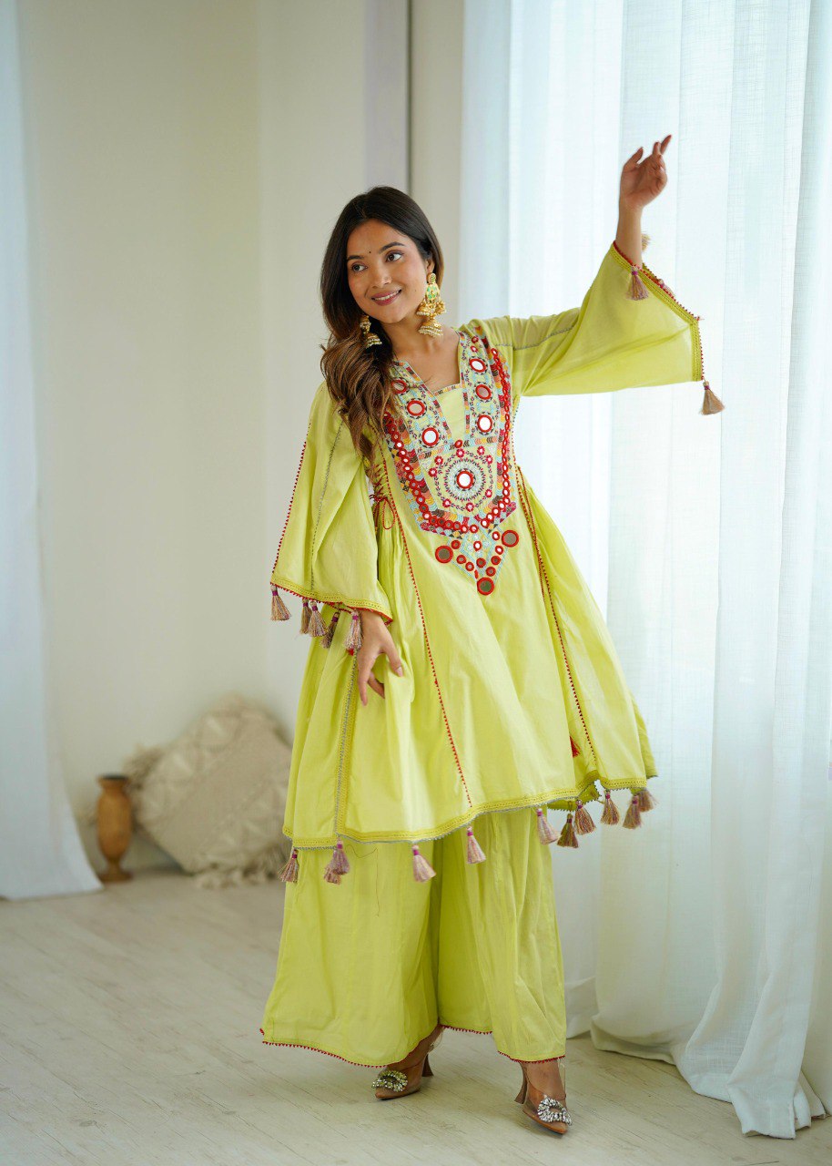 Woman wearing a lime green Khadi Cotton co-ord set with embroidered and mirror-work neckline and bell sleeves, posing outdoors.