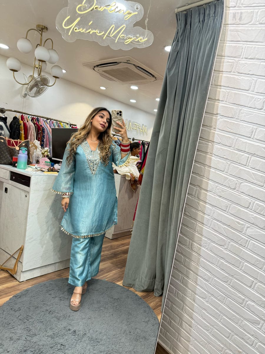 Model wearing a light blue gold crushed co-ord set with mirror work details