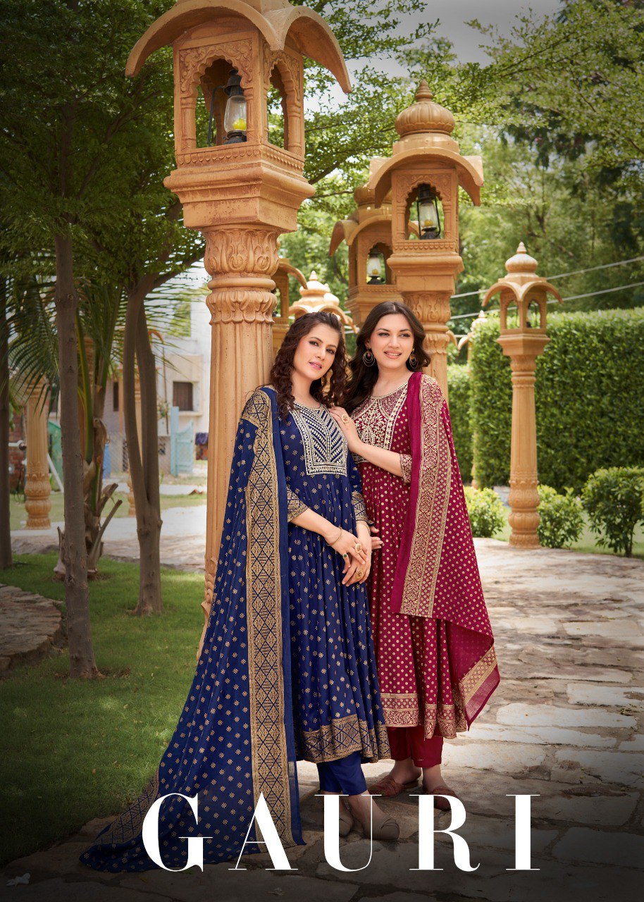 Two women posing in a garden wearing the navy blue and maroon Gauri Gown Pent Dupatta sets.