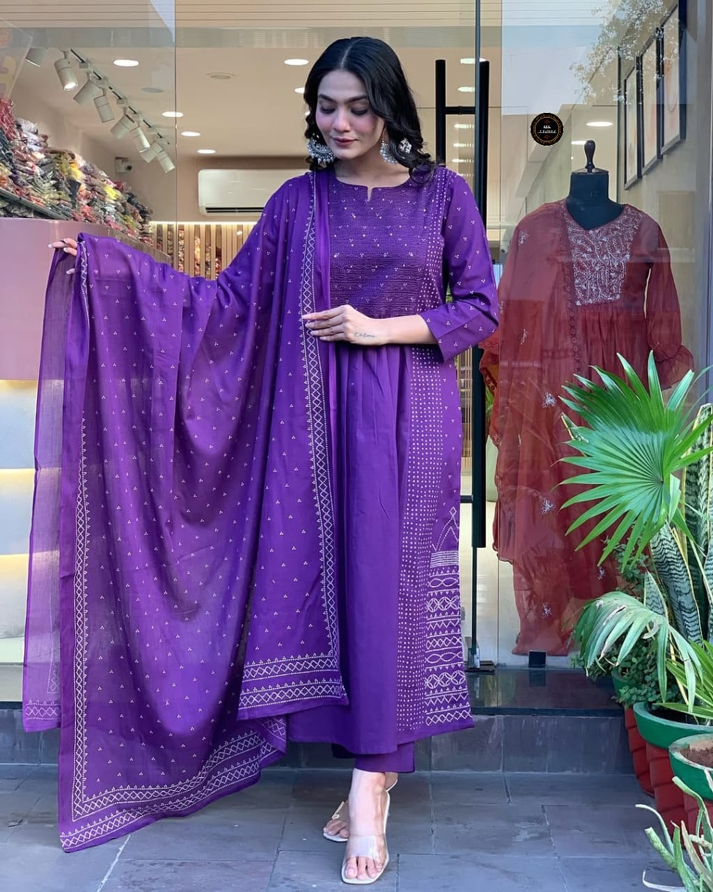 Model showcasing the full purple embroidered Chanderi kurta set with dupatta, standing elegantly in front of a store.