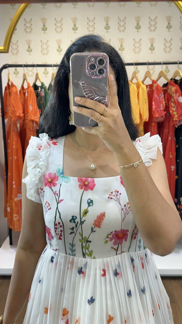 TRENDBUY model in white muslin floral midi dress, showcasing ruffled sleeves and square neckline, selfie view.