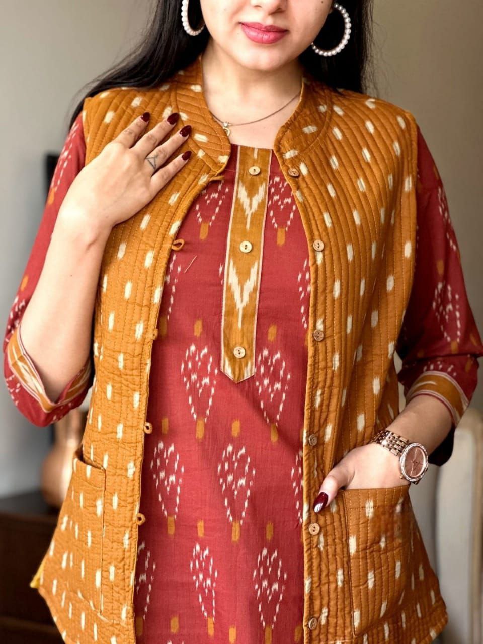 Model wearing a maroon printed kurti and mustard yellow quilted jacket, showing the set's texture and details.
