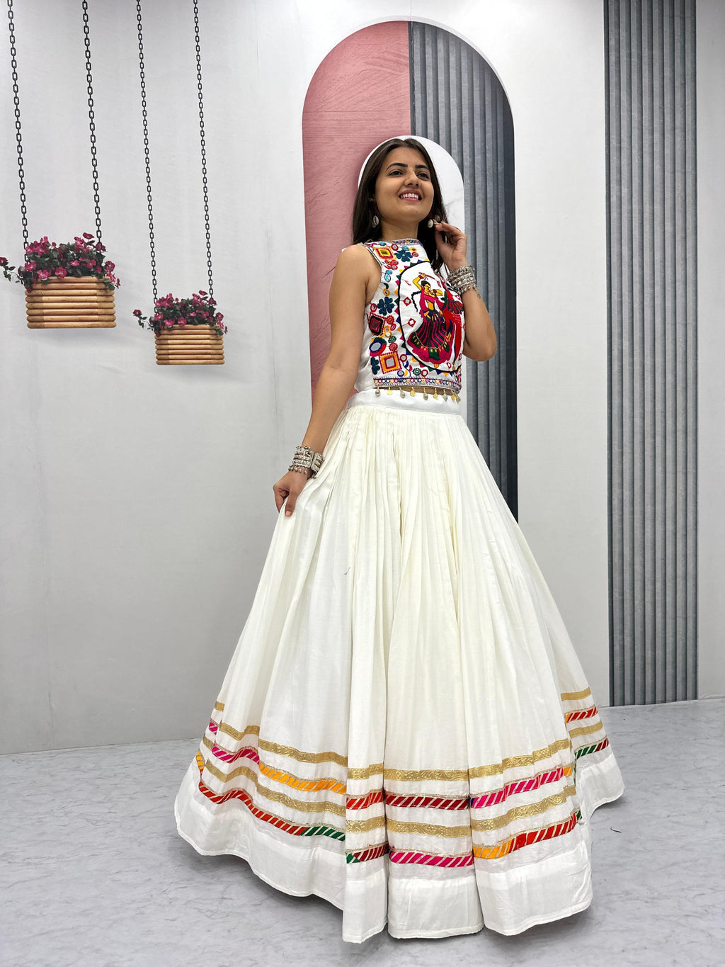TRENDBUY model posing in white Navratri Special Gamathi work and hand mirror lehenga choli with traditional jewelry, festive ethnic wear