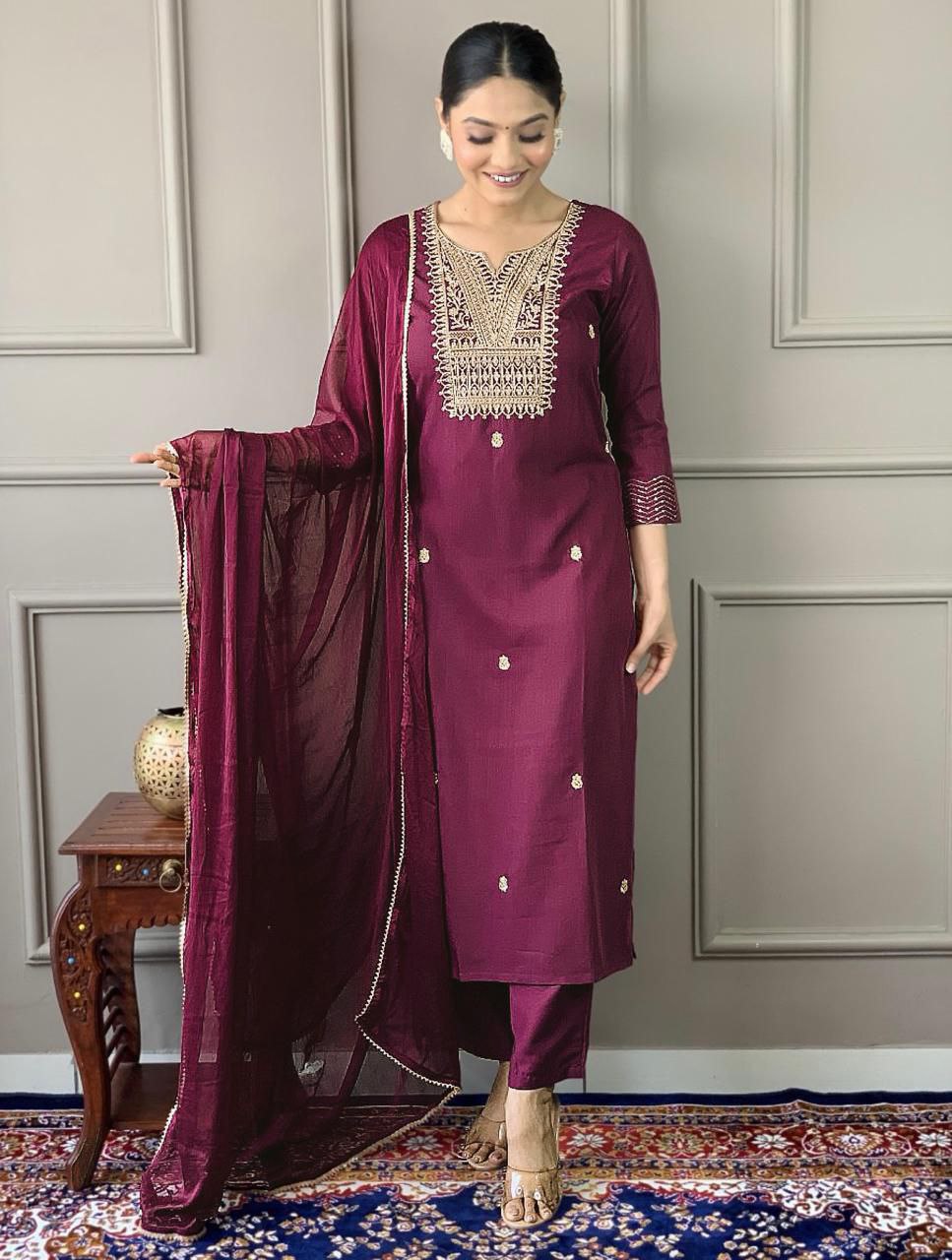Woman wearing a deep purple TRENDBUY embroidered kurta pant suit with a Chinon dupatta.