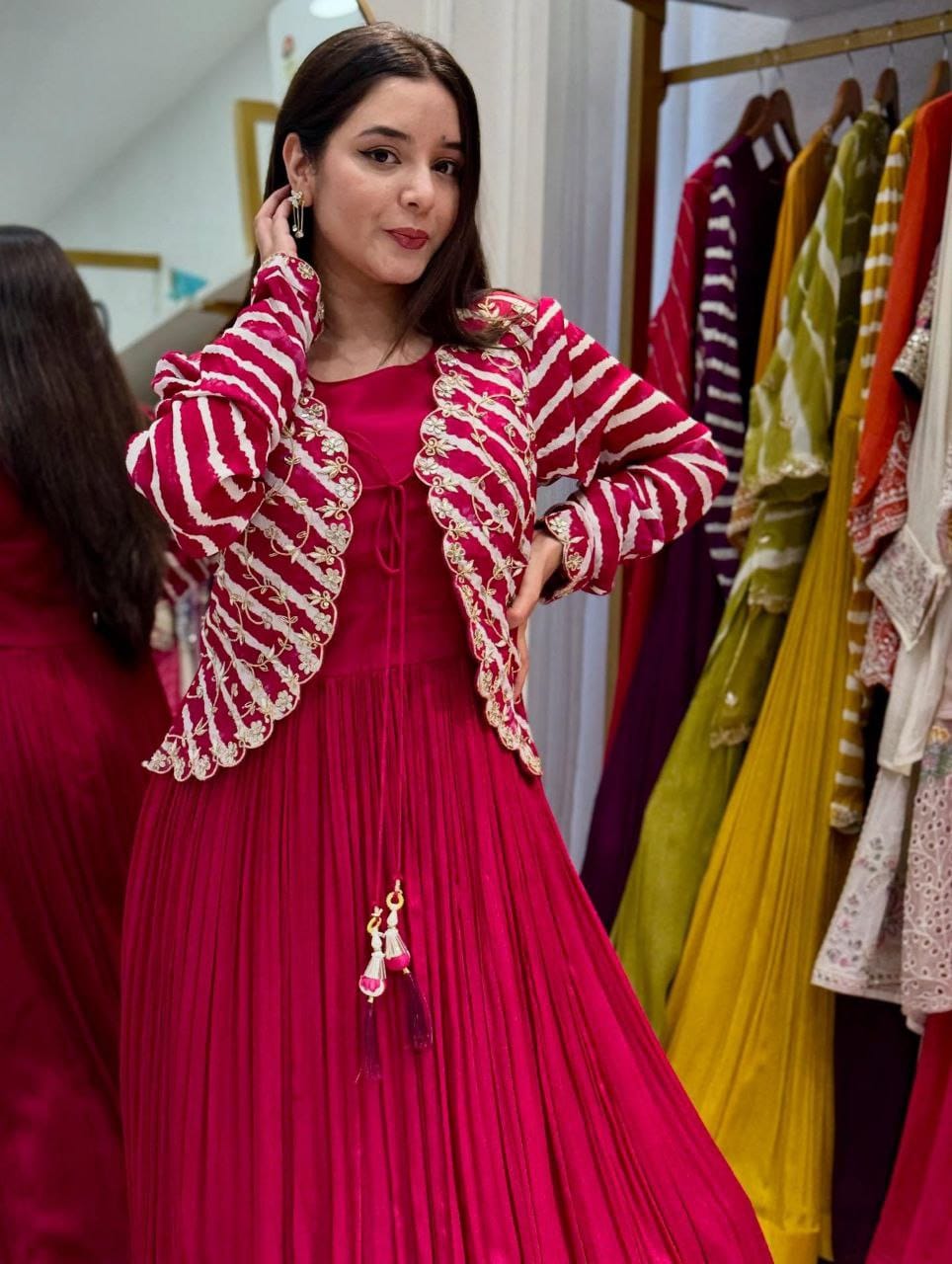 Model posing confidently in magenta fox georgette gown and striped embroidered jacket from TRENDBUY.