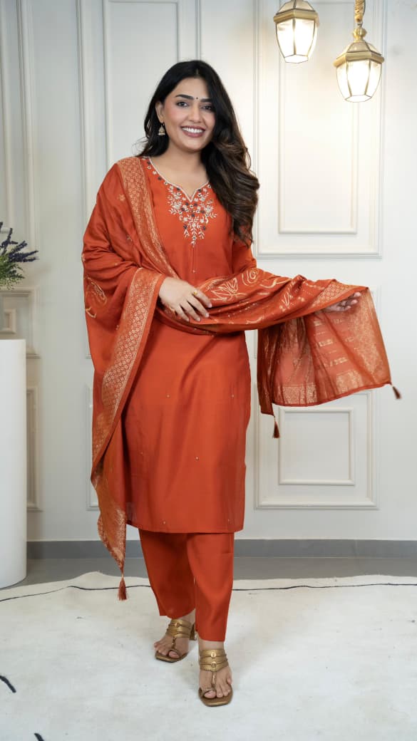 Model in full shot, showcasing the elegant rust Roman silk kurti, pent, and dupatta with hand work.