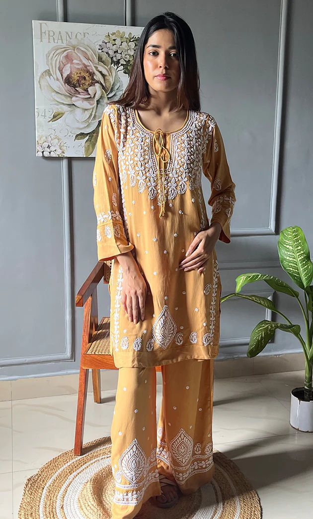 Model in golden yellow embroidered Reyon kurta plazzo set, full shot, facing front, subtle lighting.