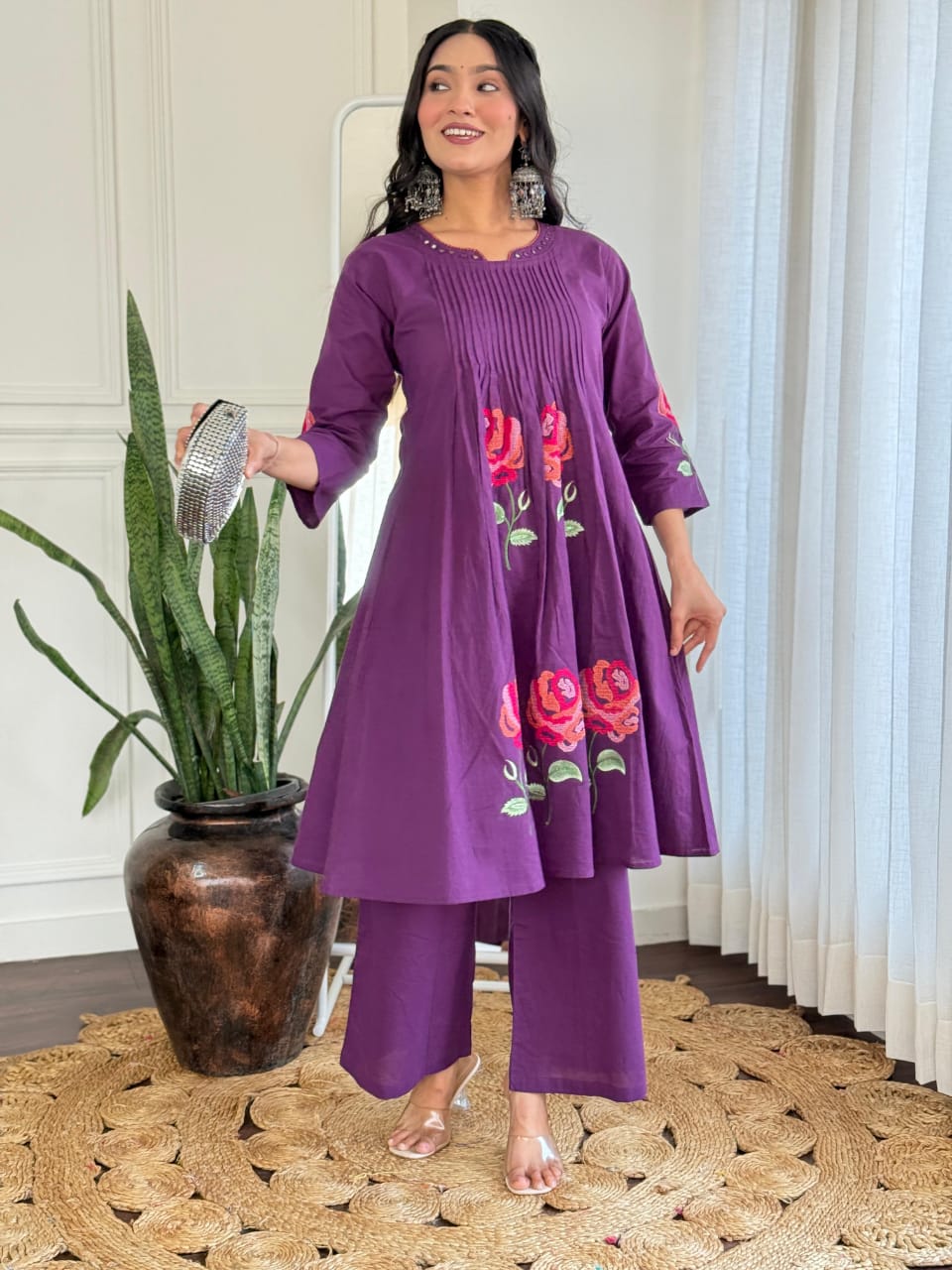 Model in TRENDBUY vibrant purple pure cotton co-ord set with pleated yoke and red floral embroidery, holding a metallic clutch.
