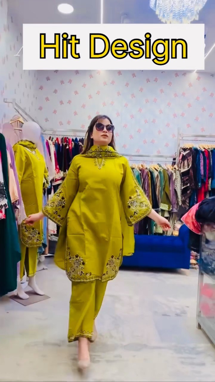 Model gracefully walking in TRENDBUY premium lime green embroidered Roman Silk kurta set with dupatta in a boutique setting.