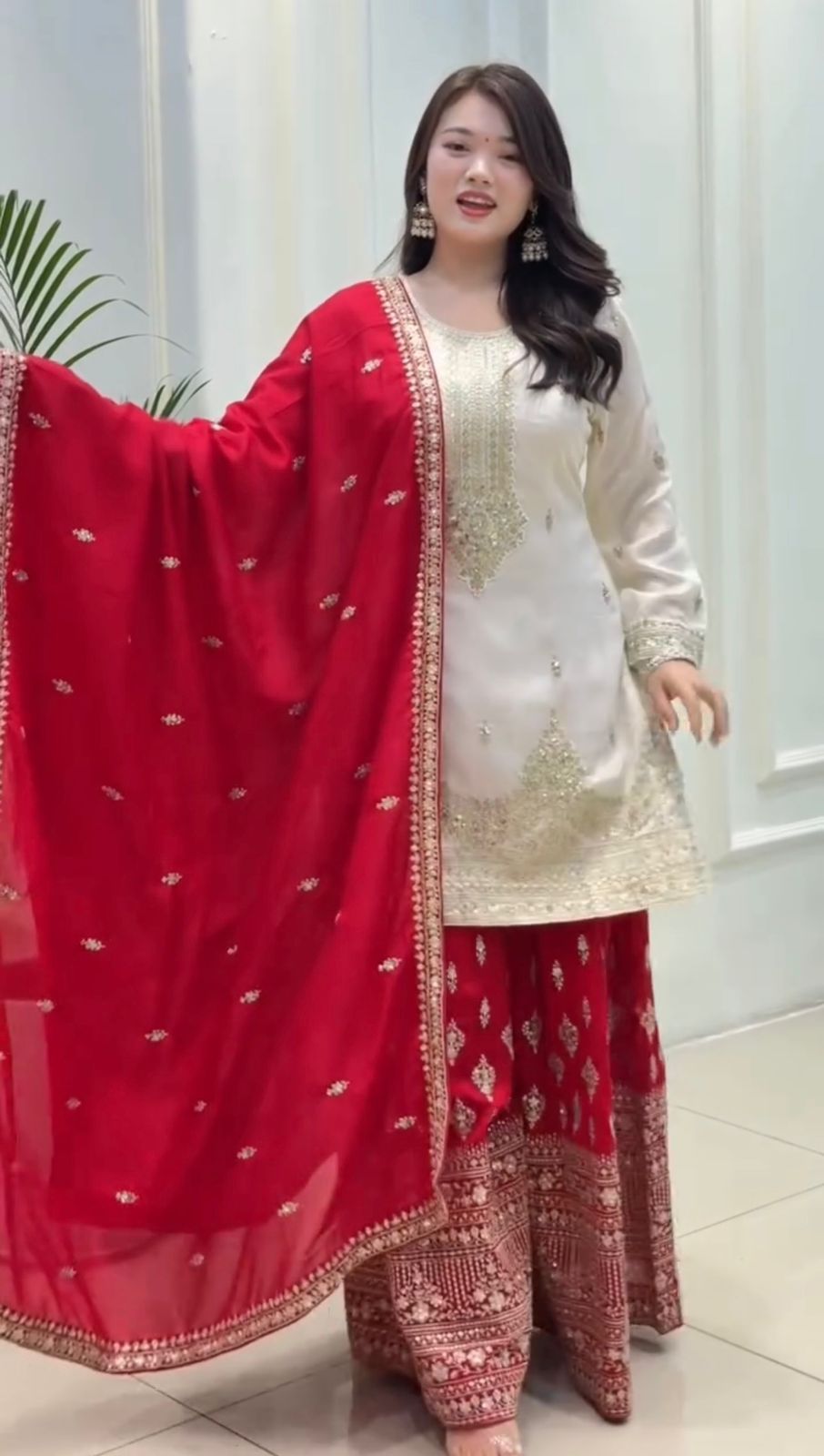 TRENDBUY model in elegant white Chinon silk top and red sequence embroidered plazzo with matching dupatta.