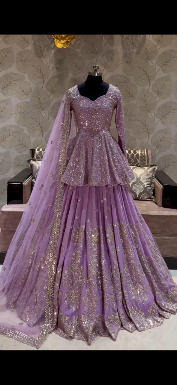 TRENDBUY lavender faux georgette peplum top lehenga gown with heavy sequence embroidery on mannequin.