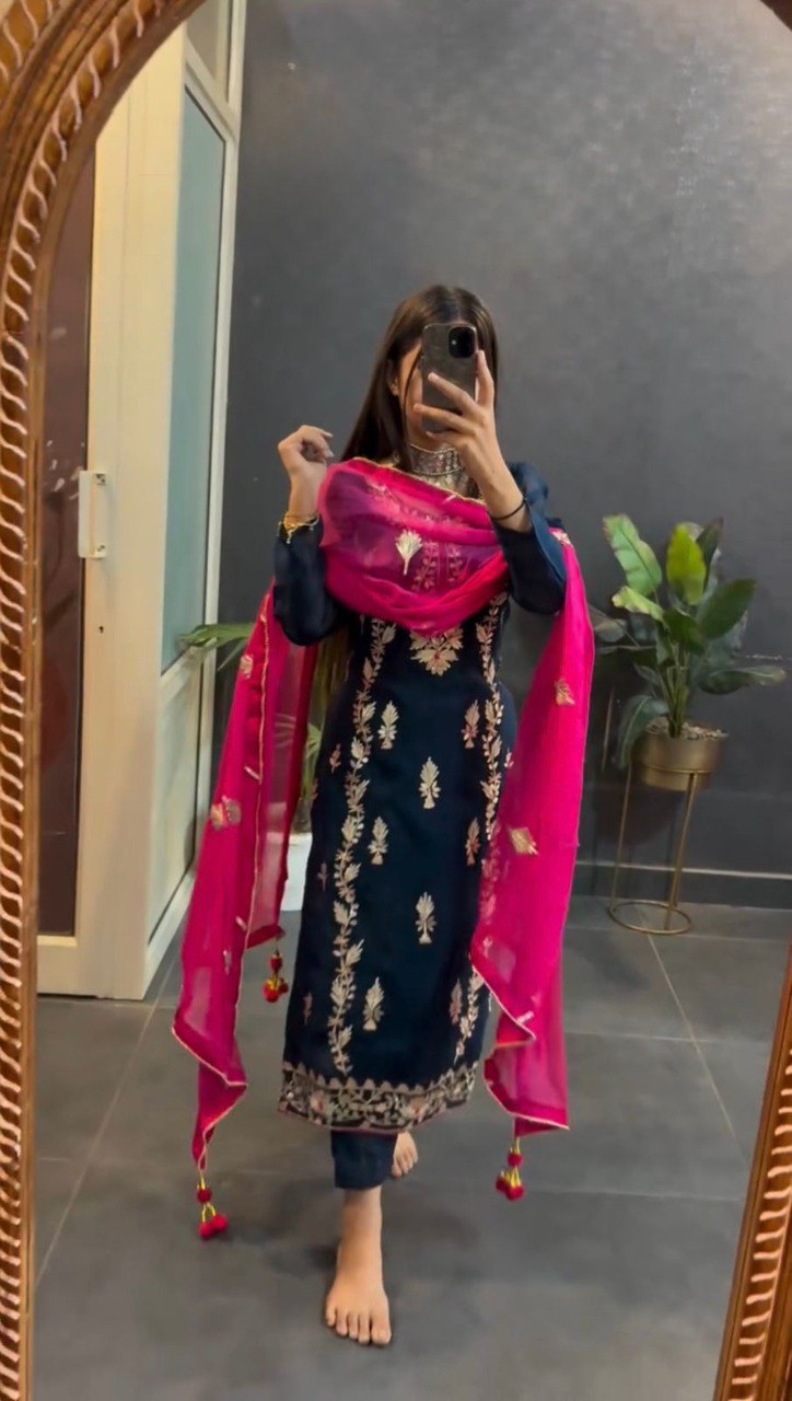 Model wearing TRENDBUY navy blue chinnon silk kurta set with intricate embroidery and hot pink georgette dupatta, mirror selfie