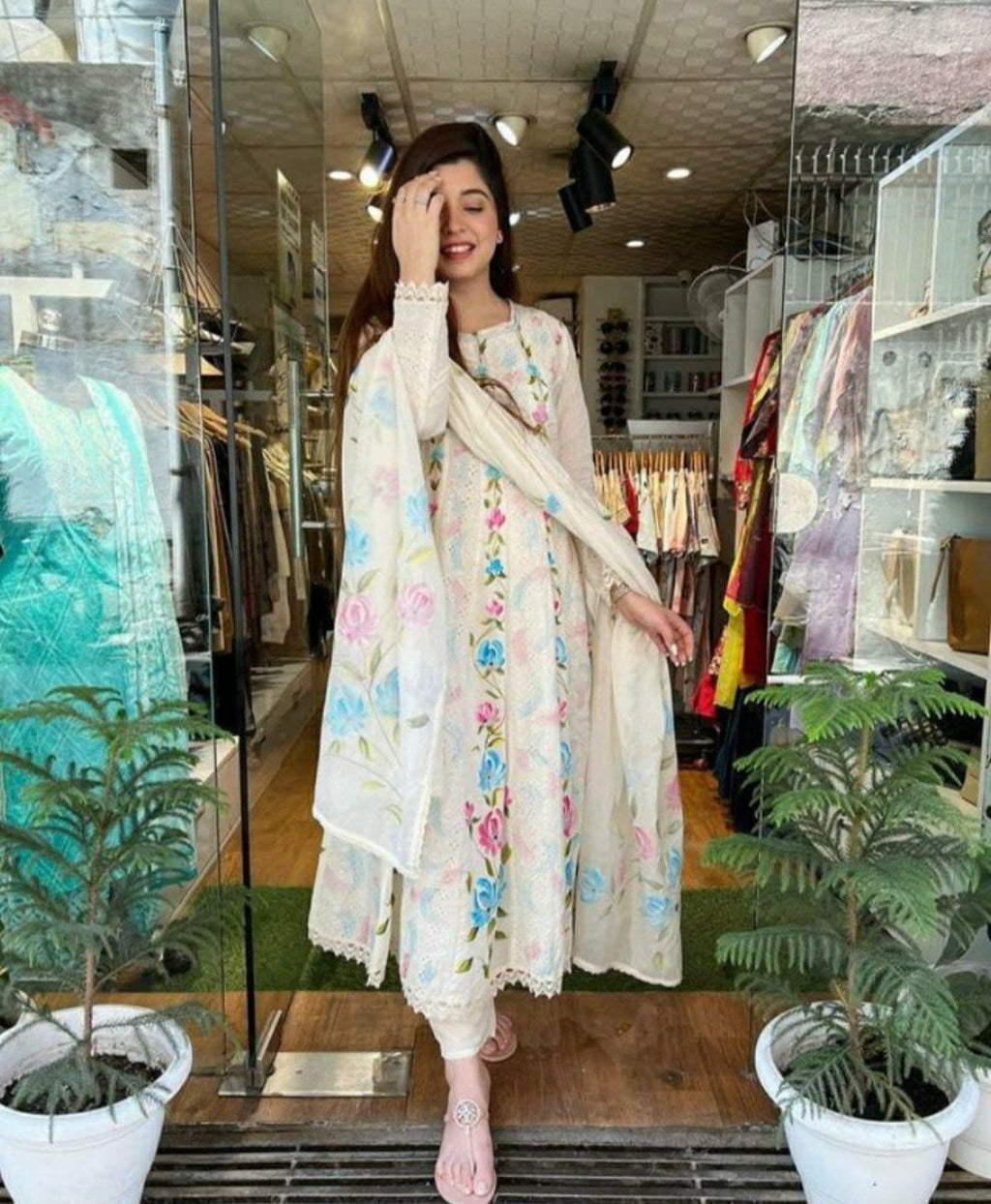 Model showcasing TRENDBUY Hand-Painted Chicken Shifli Anarkali Kurta Set in a boutique setting, smiling.