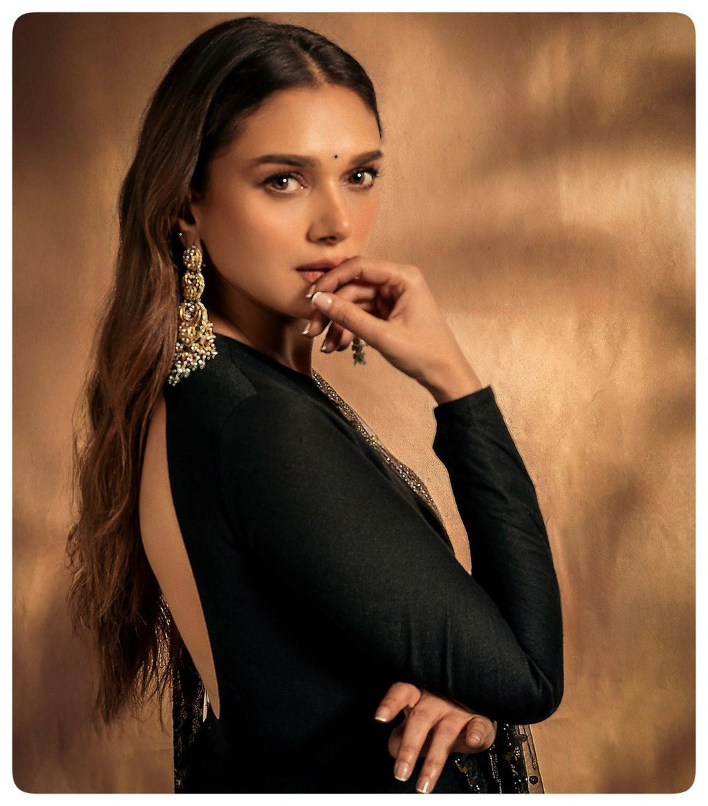 TRENDBUY Sachi Inspired black Anarkali gown with long sleeves and open back, featuring large gold and pearl chandelier earrings