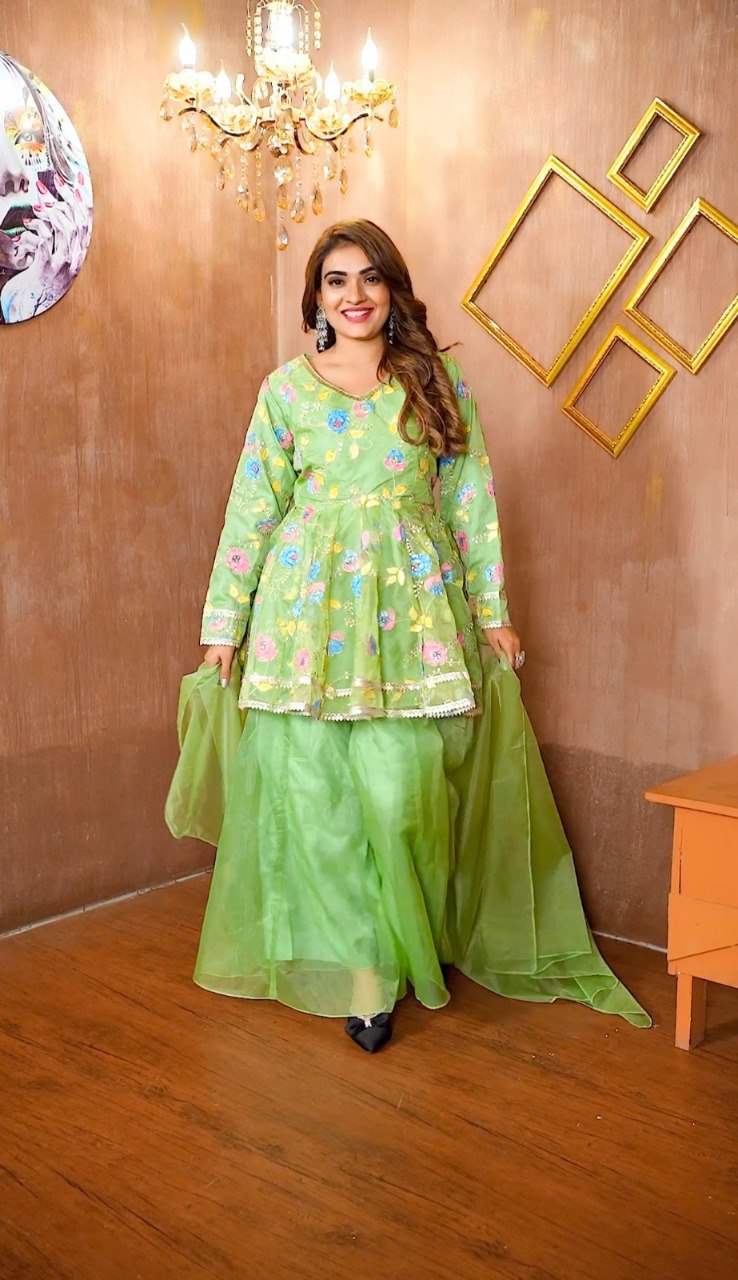 Full-length shot of model in vibrant green organza palazzo suit with floral embroidery.