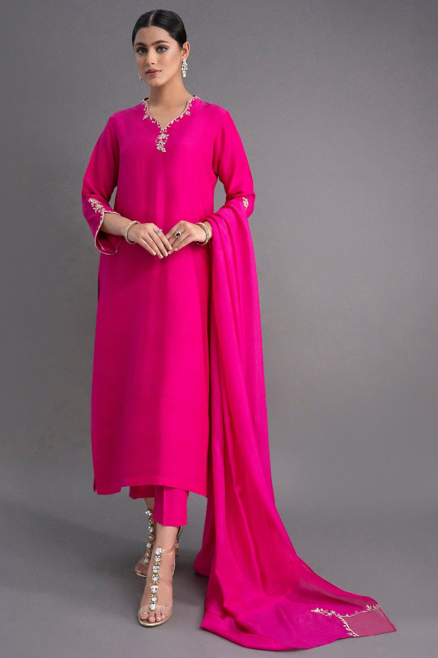 Full-length view of a model wearing an elegant fuchsia pink straight kurti pant dupatta set with delicate embroidery on the neckline and sleeves.