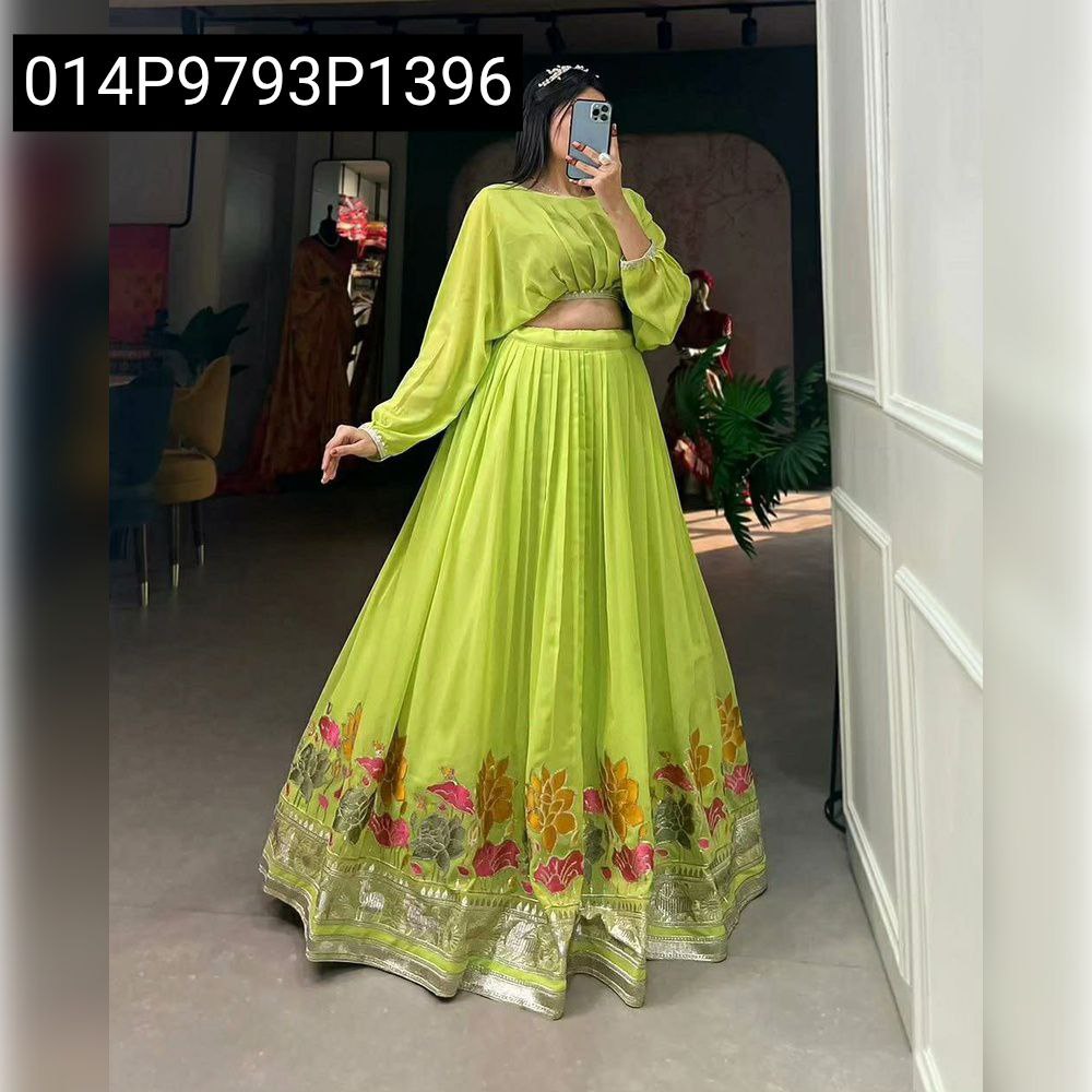 Front full body shot of a woman in a bright lime green embroidered faux georgette pleated lehenga with a distinctive floral border and matching blouse.
