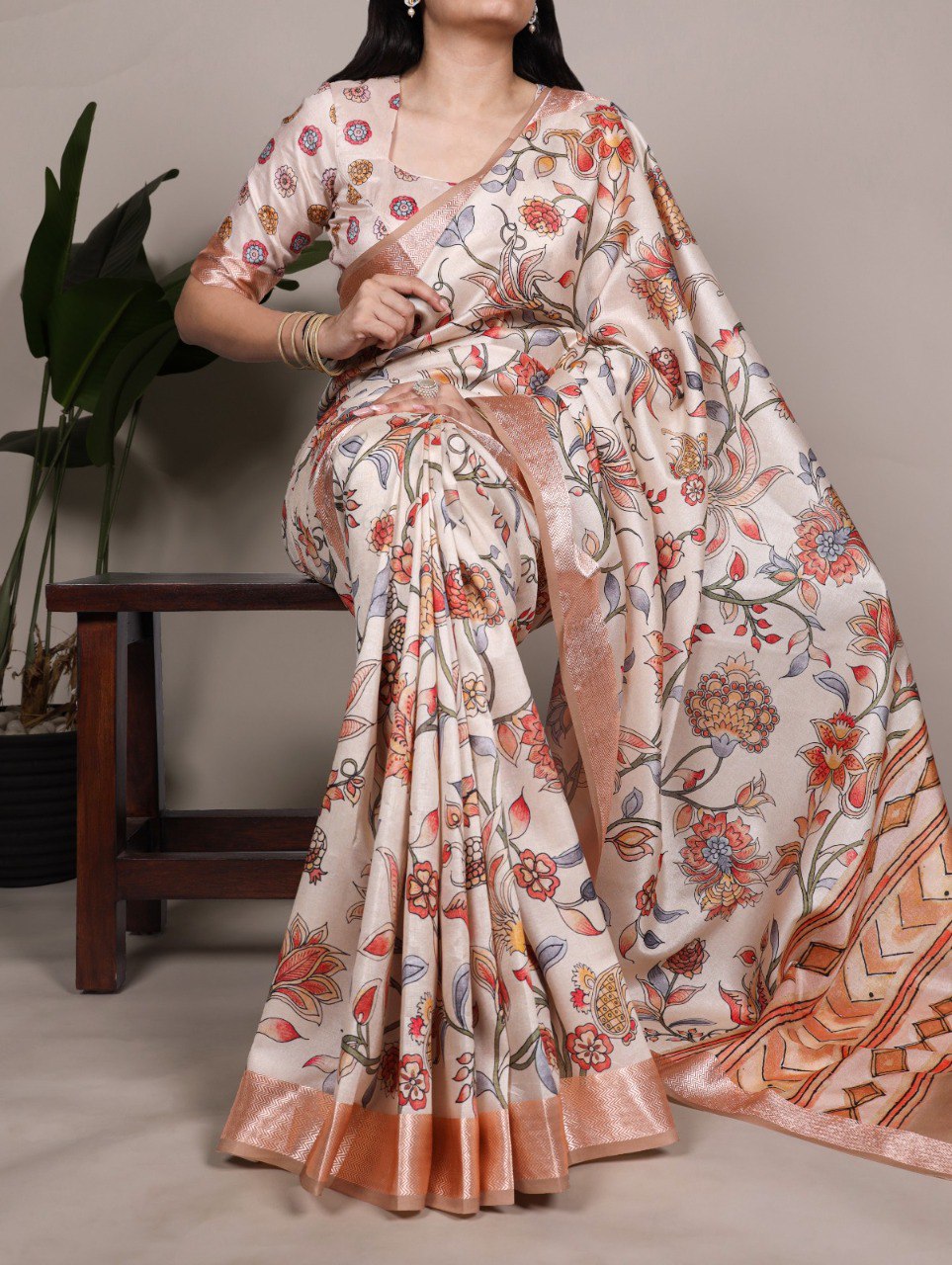 Woman in elegant Champagne Floral Tasar Silk Saree with copper border, posing gracefully.