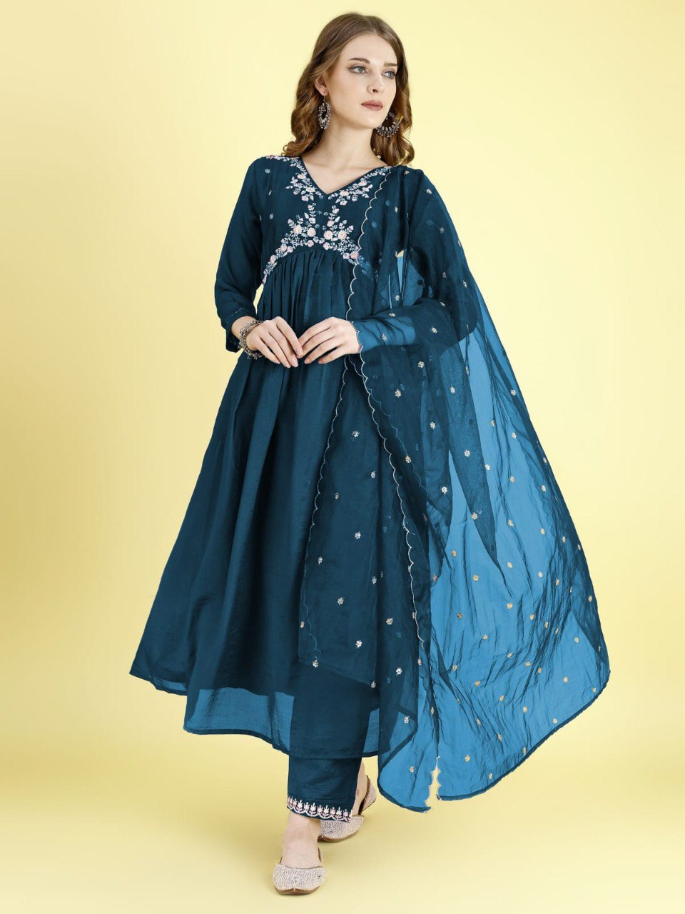 Model in Teal Blue Alia Cut flared kurti set, embroidered V-neck, net dupatta. Front view.