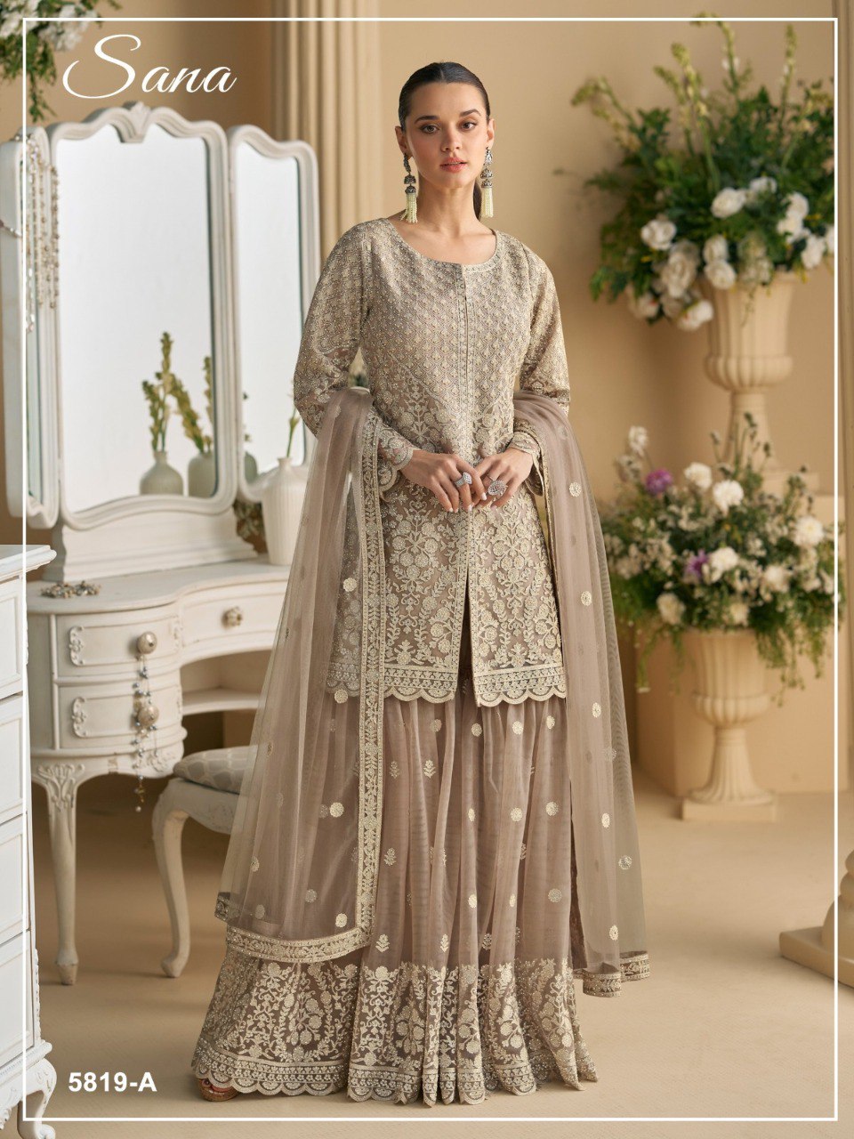 TRENDBUY elegant beige Net Silk Sharara Suit with heavy sequence embroidery, modeled confidently.