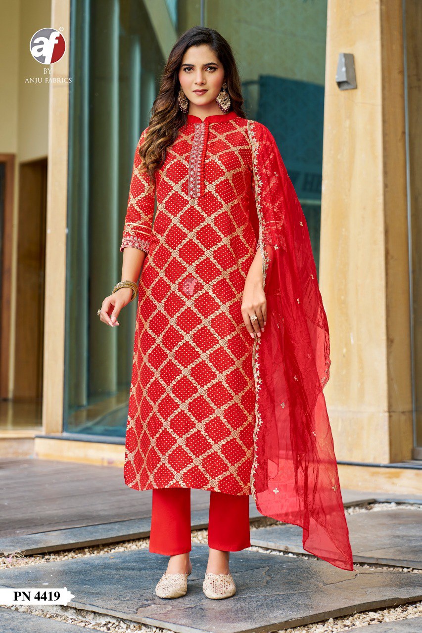 Model showcasing a vibrant red Russian Silk Jacquard kurti pant set with Organza dupatta and lace details, front view.