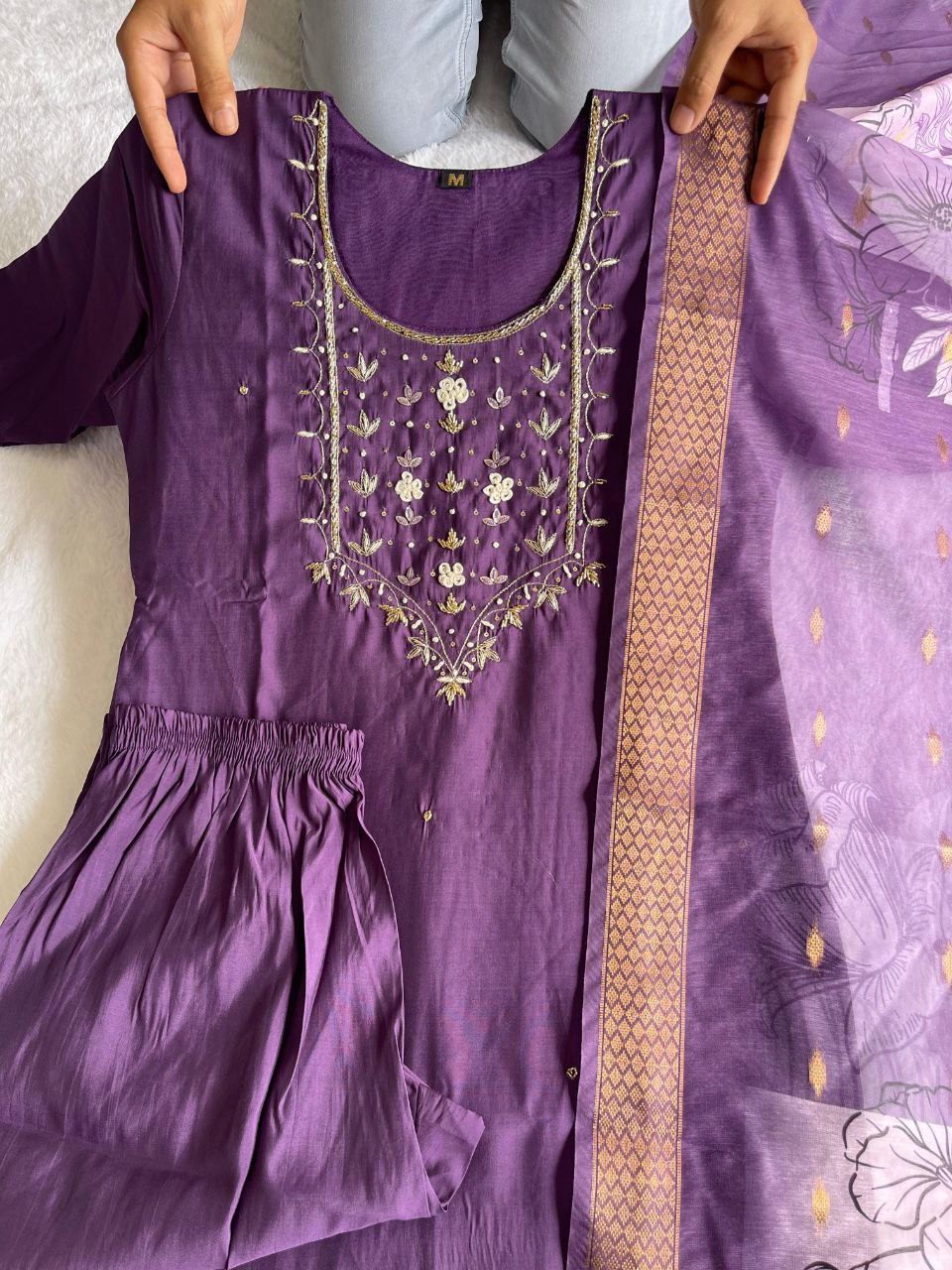 Close-up of the intricate handwork embroidery on the neckline