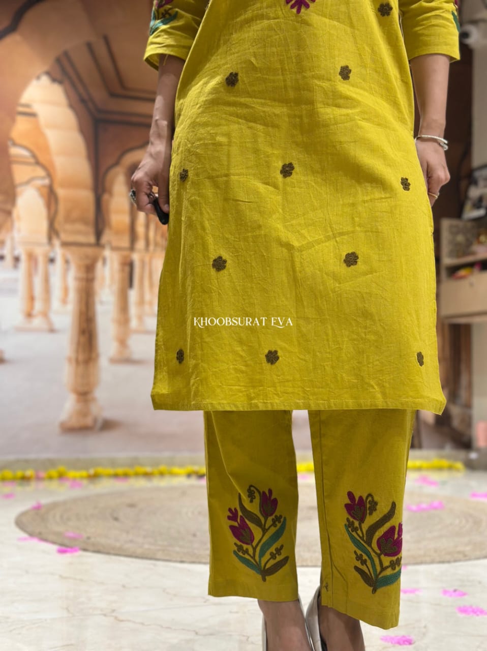 Close-up of intricate floral Aari embroidery on the neckline