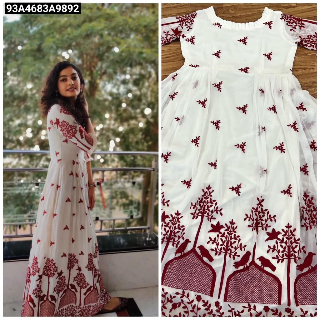 White dress with red floral patterns worn by a woman outdoors, and close-up of the dress on a wooden surface.