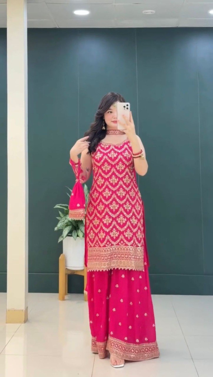 Model posing in a vibrant hot pink Faux Georgette Top Plazzo Set with gold embroidery and sequence work.