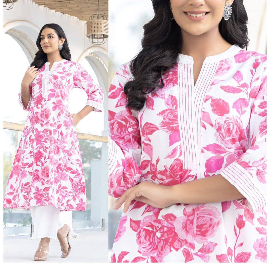 Woman posing in a white and pink floral digital print Twill Rayon kurta set with white plazoo, showcasing the v-neck detail.