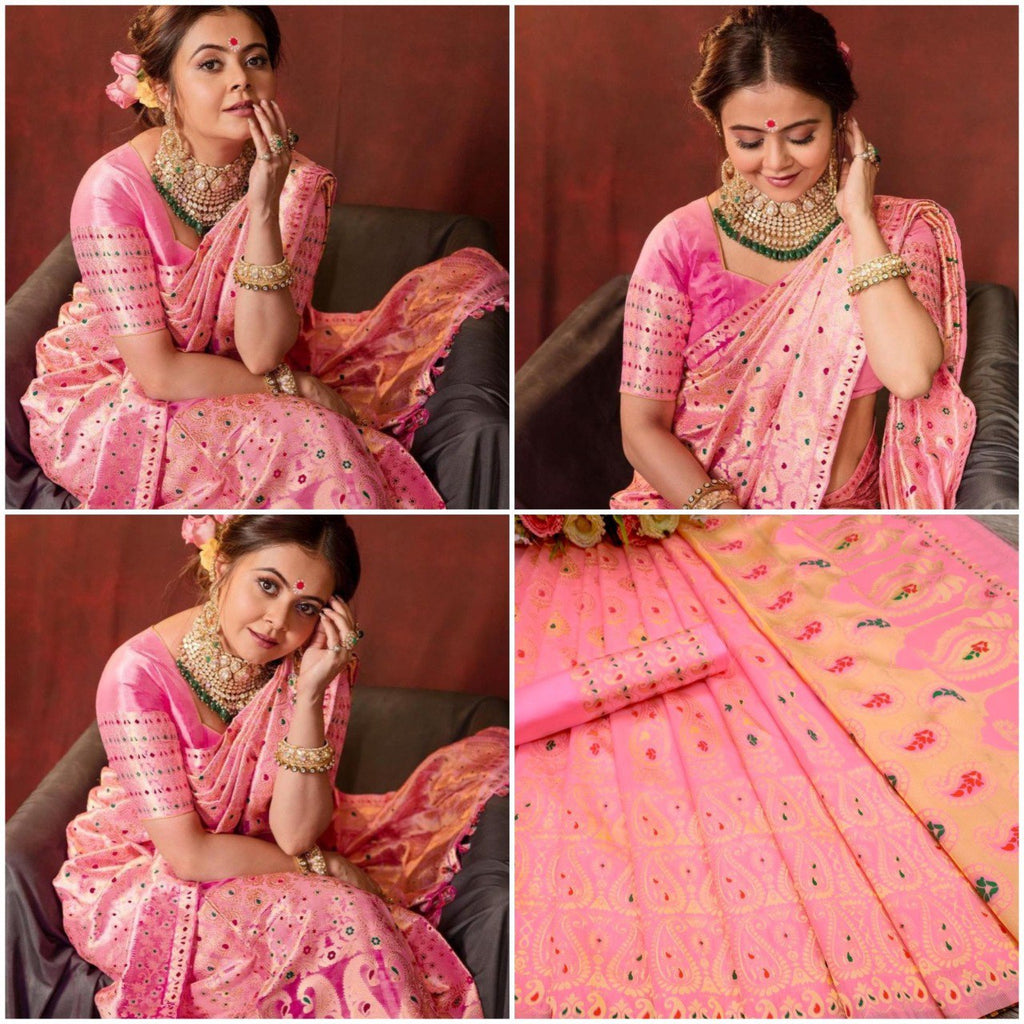 Model in elegant pink Lichi silk saree with rich jacquard work, emerald choker, and bangles, seated gracefully.