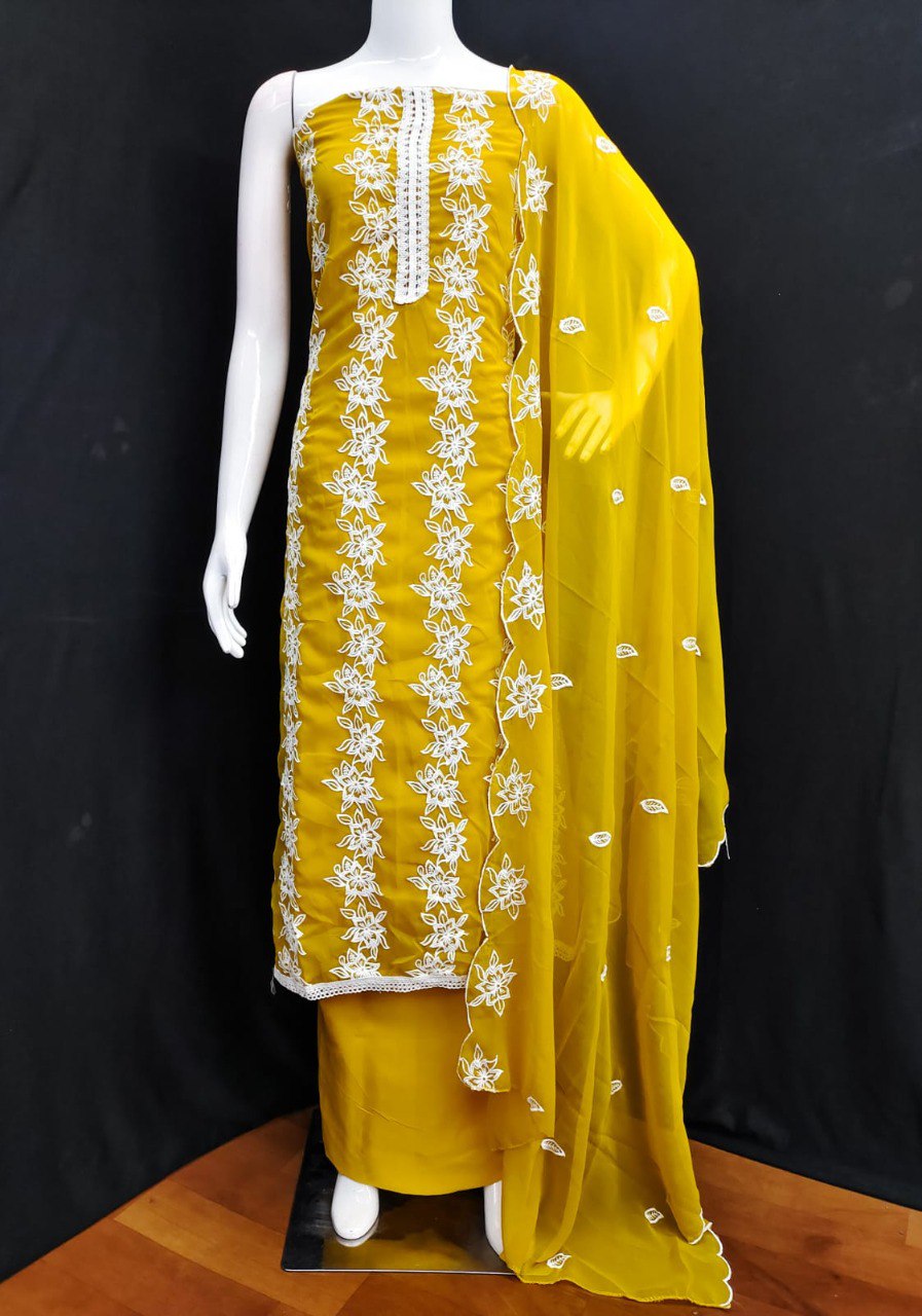 Vibrant yellow Georgette embroidered unstitched salwar suit on mannequin, showcasing intricate white floral embroidery and matching dupatta.