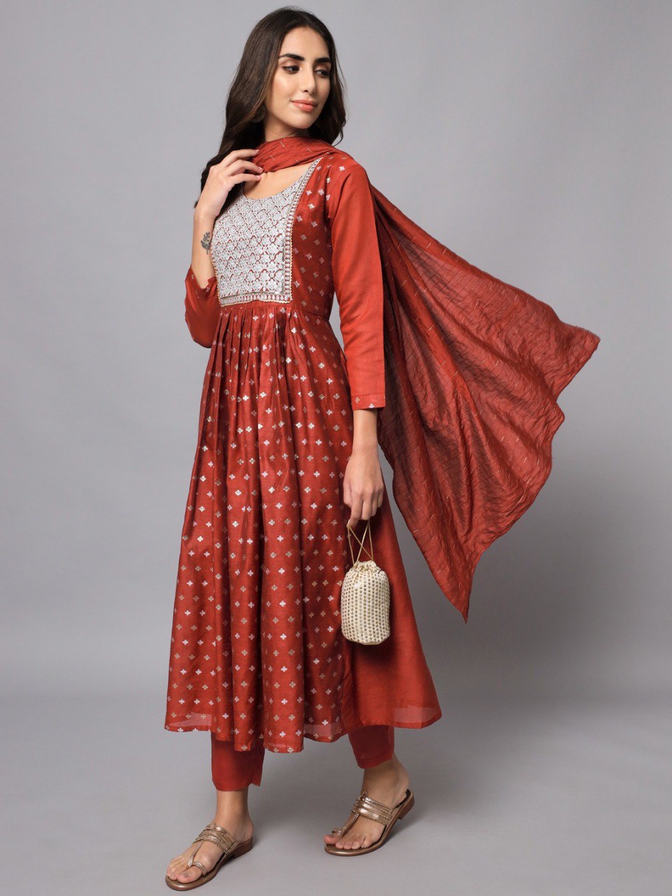 Rust orange flared Chanderi modal kurta set with embroidered yoke, styled with trousers and a flowing matching dupatta.