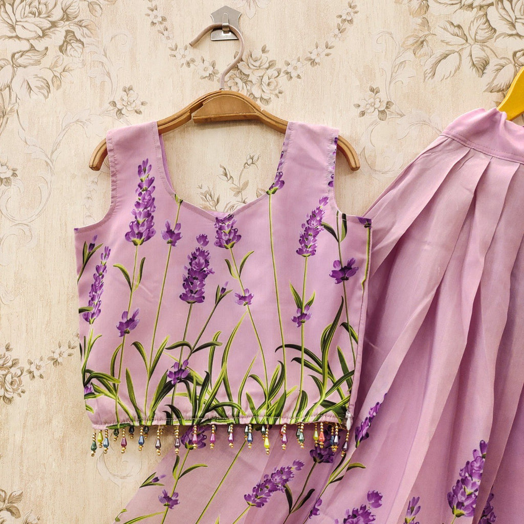 Close-up of a lavender muslin silk kids lehenga choli blouse with green stem and purple flower prints, featuring beaded trim.