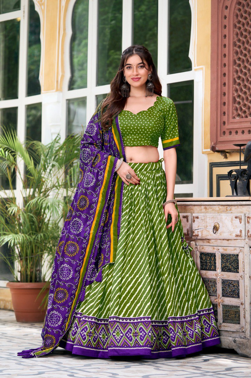 Model in green Leheriya Patola print Tasar Silk Lehenga Choli with purple Bandhej print dupatta, posing elegantly.