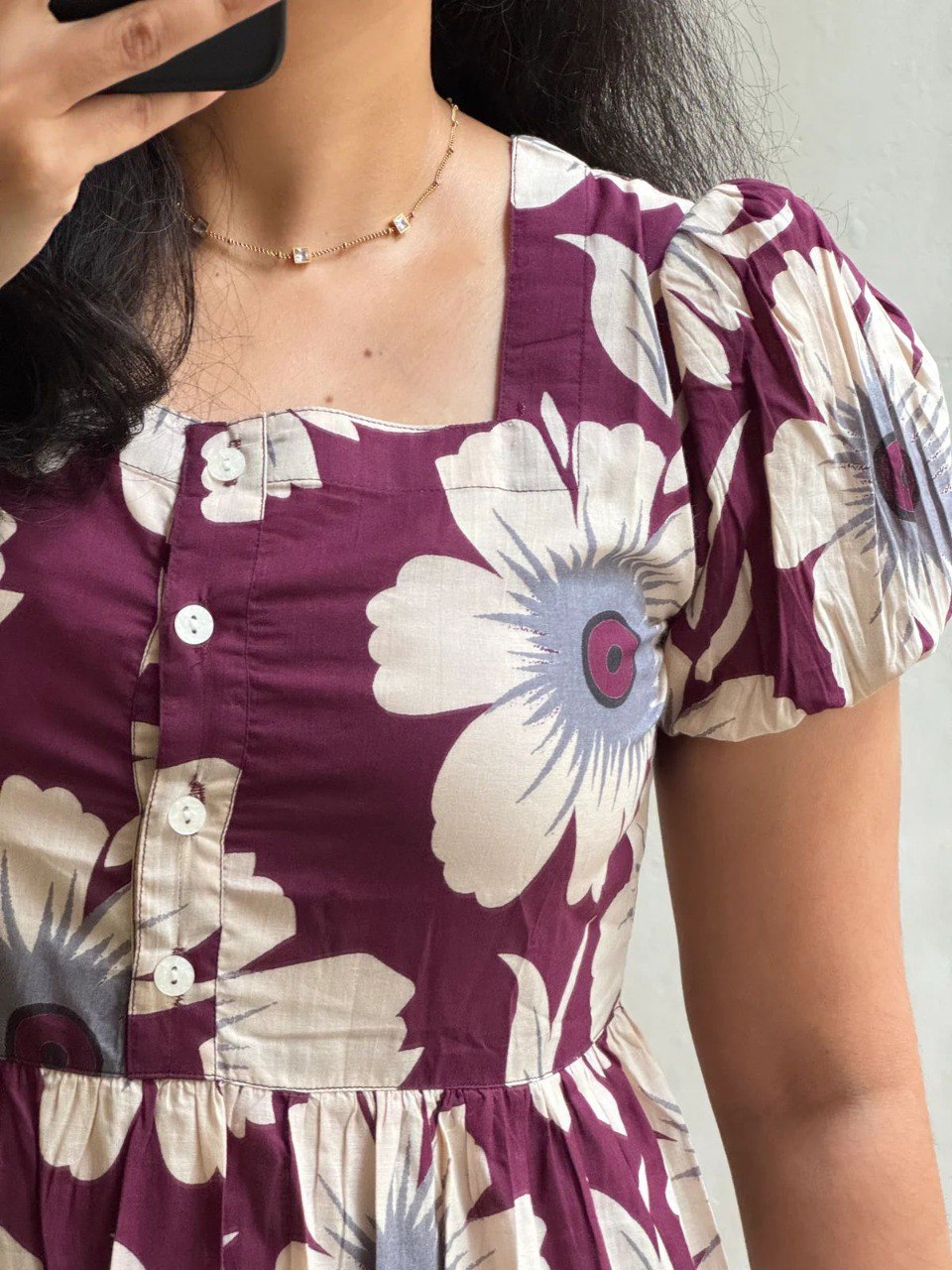 Close-up of a woman wearing the maroon floral soft cotton midi dress, showcasing the square neckline and puffed sleeves.