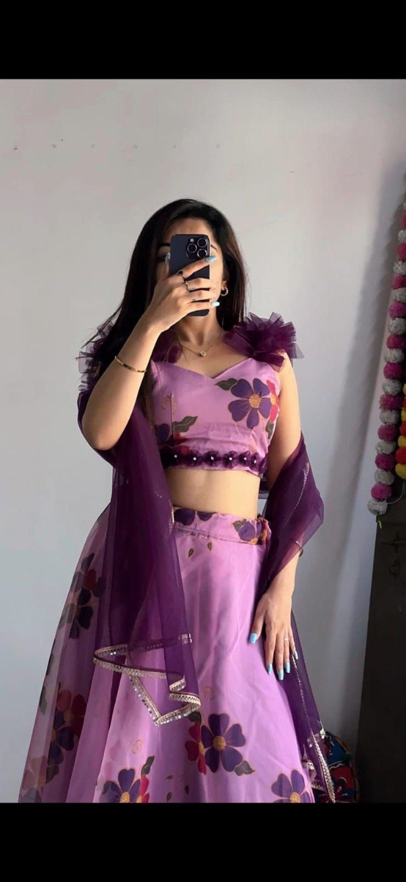 Model in Lavender Floral Organza Lehenga Choli with mirror work blouse and net dupatta, full length, selfie pose.