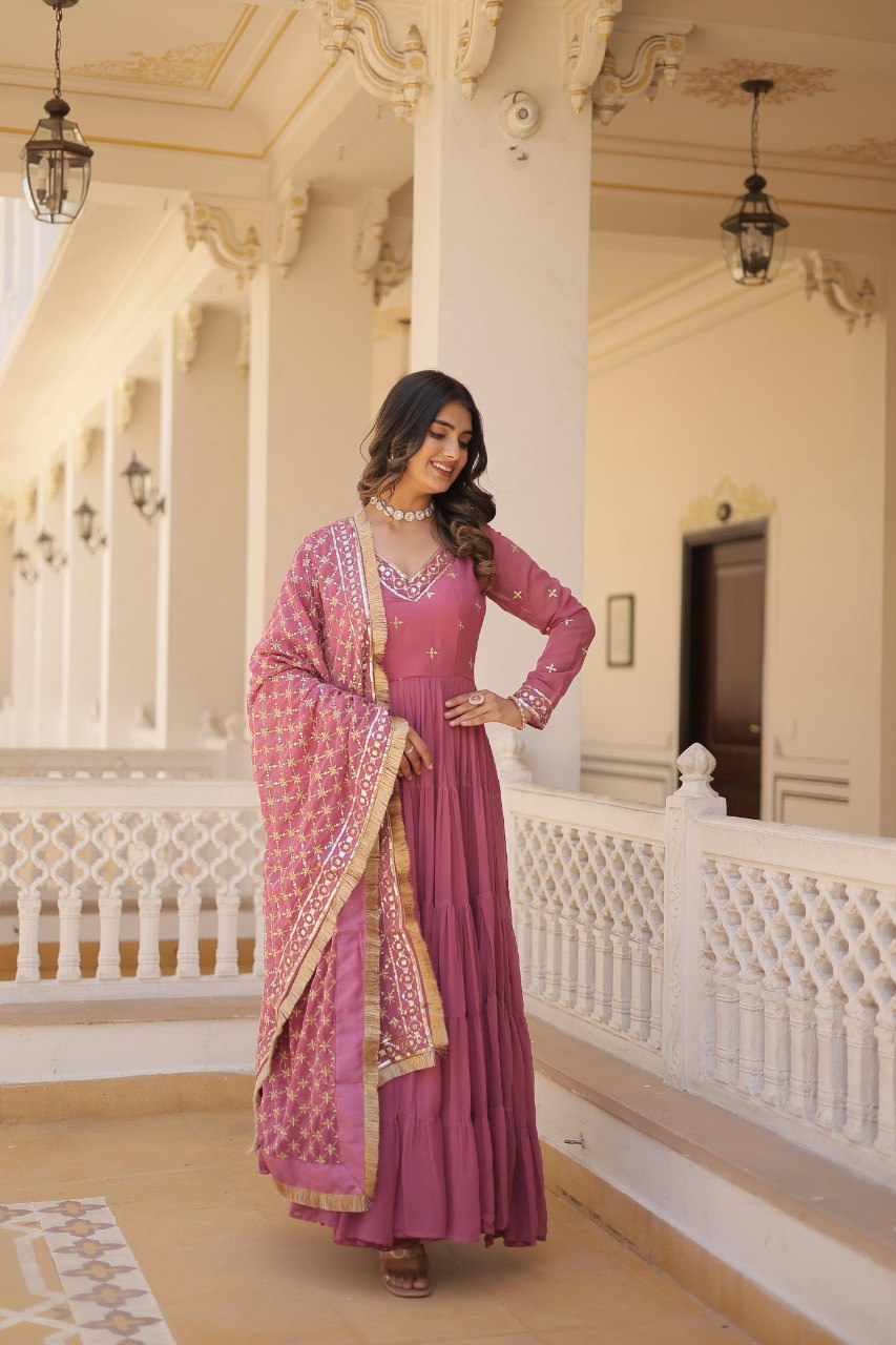 Model showcasing TRENDBUY Onion Pink Gown with Sequins Dupatta, elegant pose on balcony