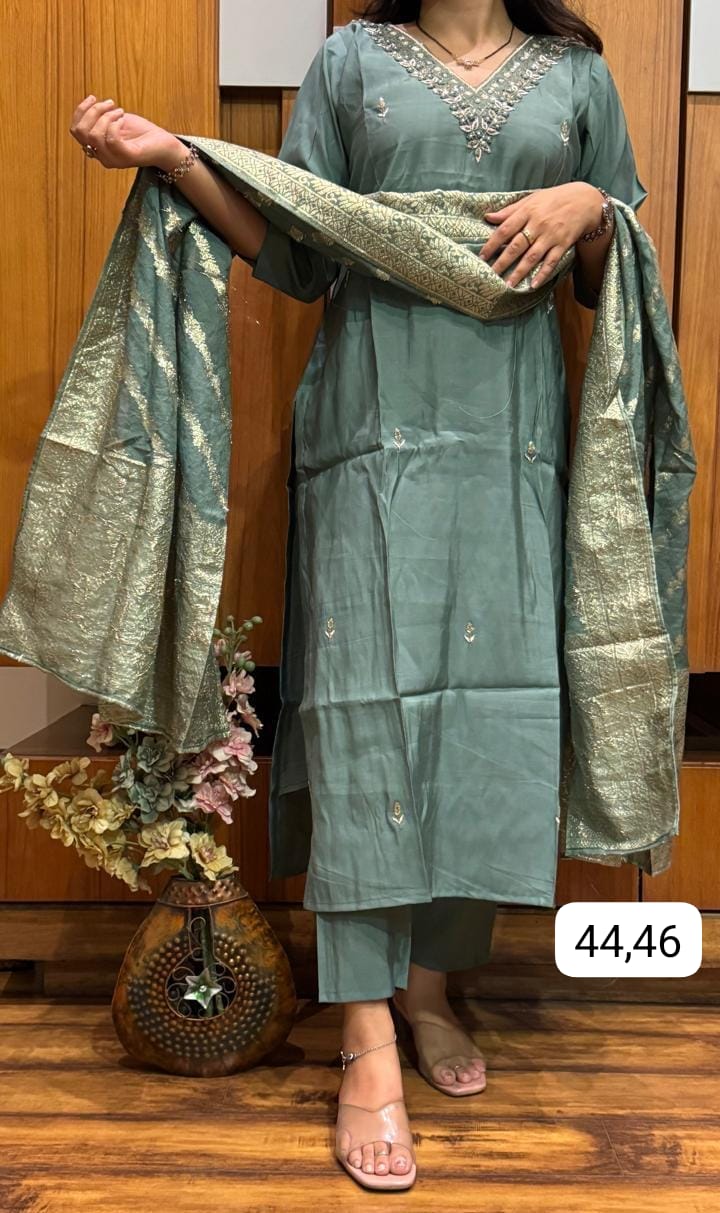 Model in sophisticated Teal Green Roman Silk kurti set with V-neck hand embroidery and matching Banarsi dupatta, showcasing elegant party wear.