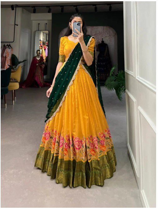 TRENDBUY model showcasing a vibrant yellow cotton silk lehenga choli with green embroidered dupatta, front view.