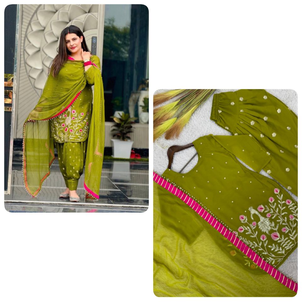 Model wearing an olive green faux georgette dhoti suit with embroidery and sequins, posing elegantly.