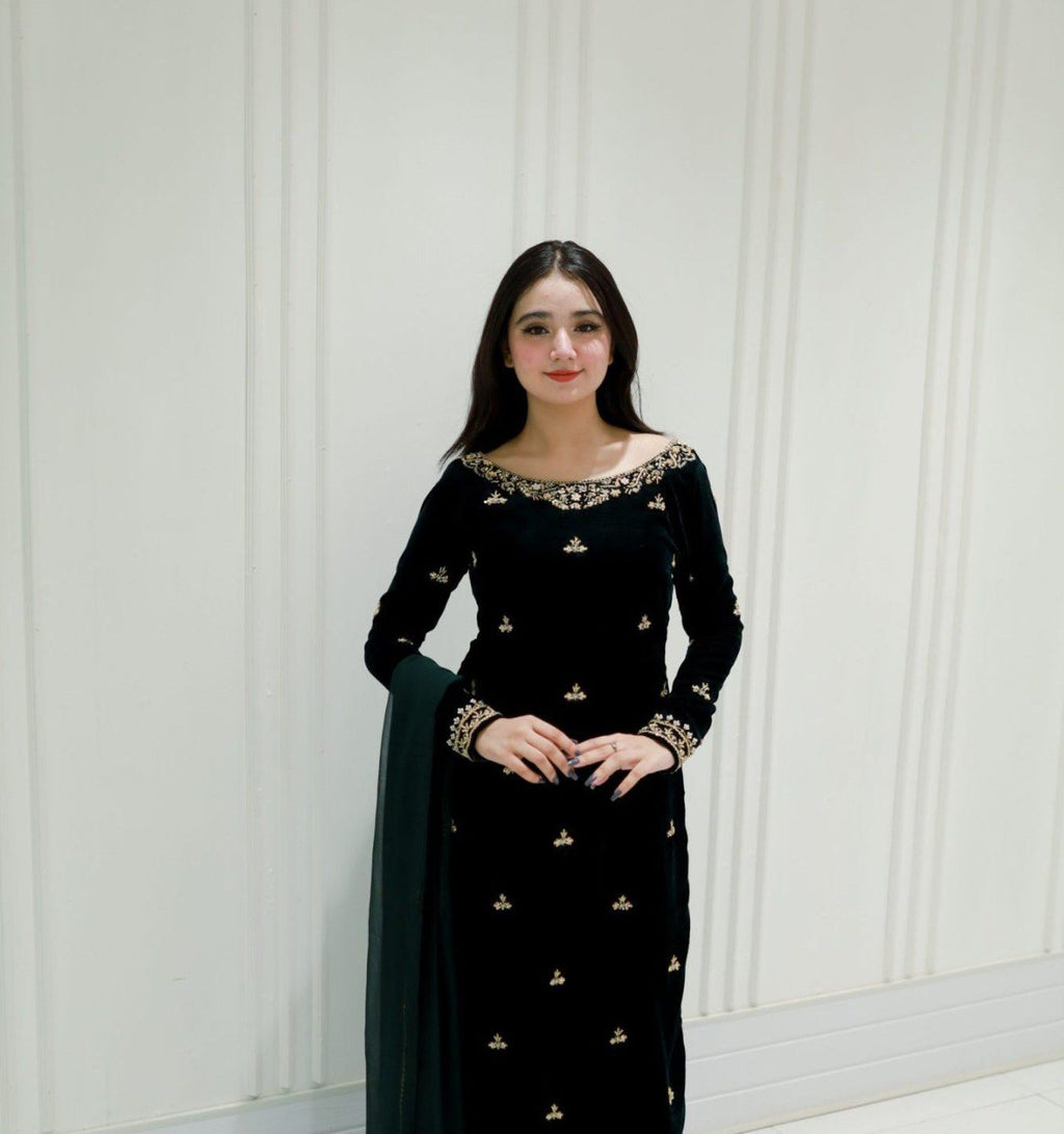 Elegant woman showcasing a dark green velvet sequence embroidered pant suit, front view.