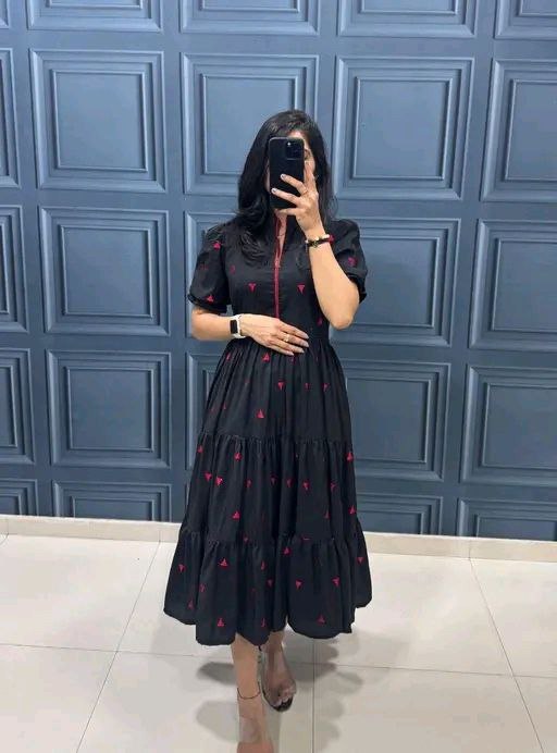 Woman showcasing TRENDBUY Black Midi Tiered Dress with Red Pyramid Print
